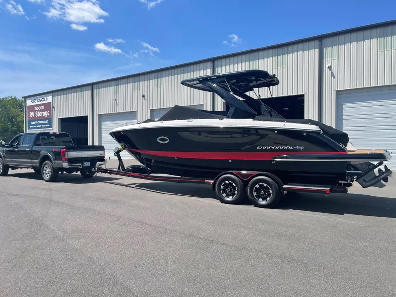 Slide: The Image of 2019 Chaparral 297 SSX boat on trailer, parked outside storage facility. - 4
