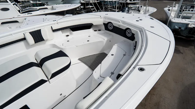 Slide: The Image of 2025 Tidewater 320 CC Adventure boat interior with white and black seating. - 10