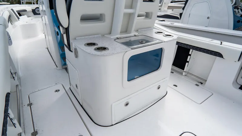 Slide: The Image of 2025 Tidewater 320 CC Adventure boat interior with seating and storage features. - 13