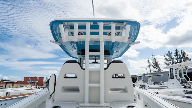 Slide: The Image of 2025 Tidewater 320 CC Adventure boat, featuring a sleek design under a blue sky. - 14