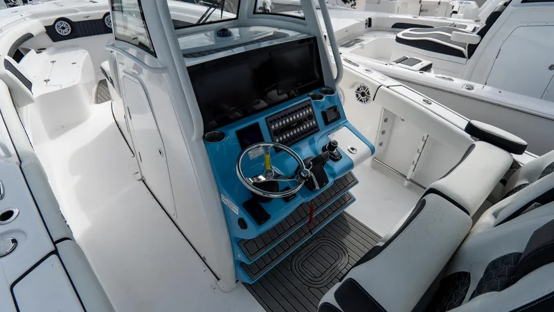 Slide: The Image of 2025 Tidewater 320 CC Adventure boat cockpit with modern controls and seating. - 17