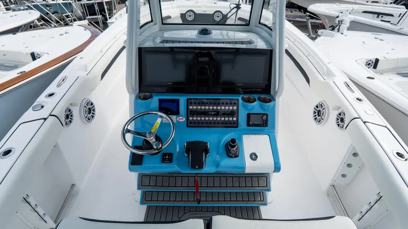 Slide: The Image of 2025 Tidewater 320 CC Adventure boat cockpit with modern controls and steering wheel. - 18