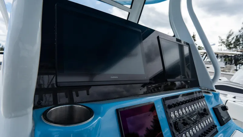 Slide: The Image of Control panel of 2025 Tidewater 320 CC Adventure boat with modern displays. - 20