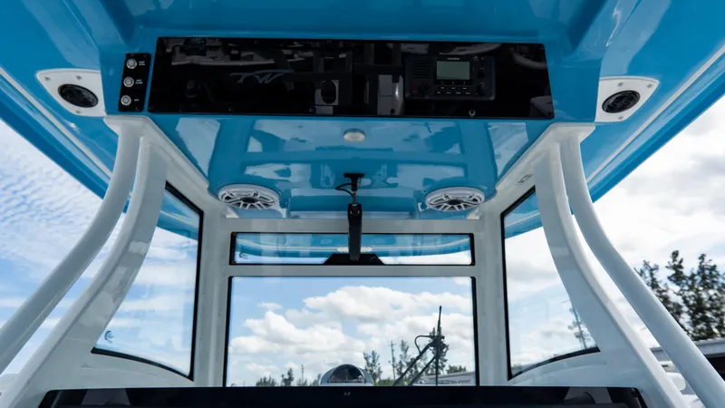 Slide: The Image of 2025 Tidewater 320 CC Adventure boat interior with blue ceiling and electronic controls. - 22