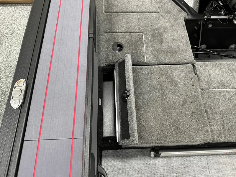 Slide: The Image of 2025 Alumacraft Trophy 185X Sport boat interior with storage compartment open. - 14