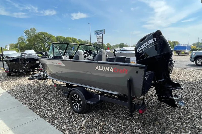 Slide: The Image of 2025 Alumacraft Trophy 185X Sport boat with 175 HP engine in showroom. - 24