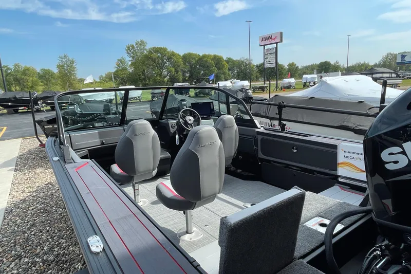 Slide: The Image of 2025 Alumacraft Trophy 185X Sport boat interior with storage and cup holder. - 26