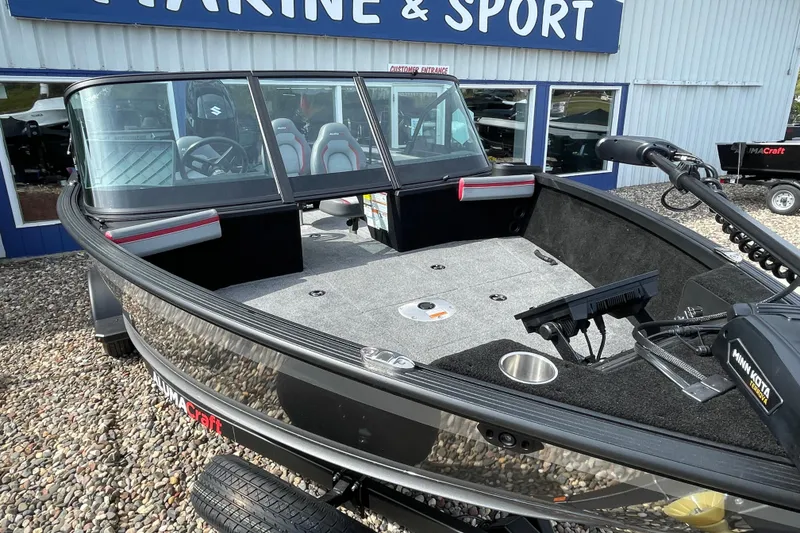 Slide: The Image of 2025 Alumacraft Trophy 185X Sport interior with dual seats and Garmin navigation system. - 28