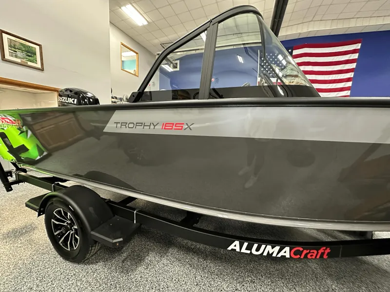 Slide: The Image of 2025 Alumacraft Trophy 185X Sport boat with Suzuki outboard motor on display. - 3