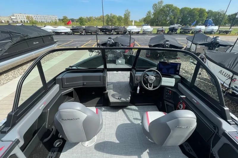 Slide: The Image of 2025 Alumacraft Trophy 185X Sport boat interior with sleek dashboard and windshield design. - 30