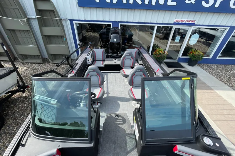 Slide: The Image of 2025 Alumacraft Trophy 185X Sport boat interior with Garmin navigation system and steering wheel. - 32