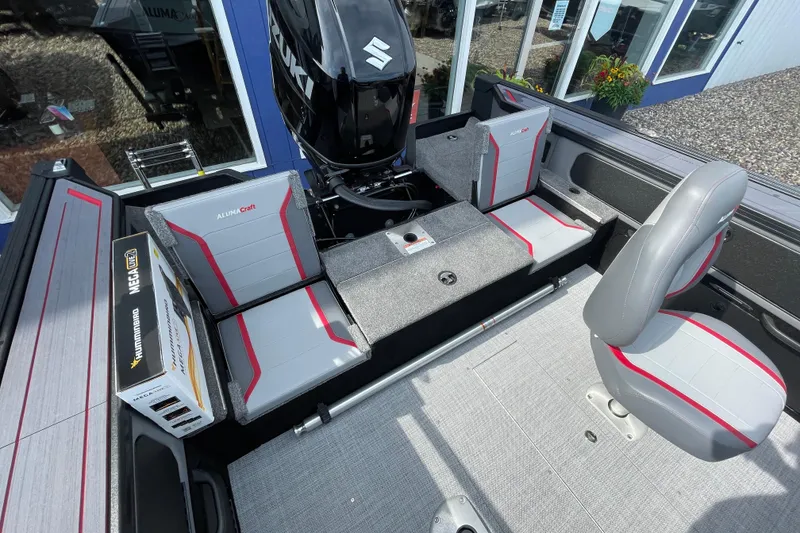 Slide: The Image of 2025 Alumacraft Trophy 185X Sport boat dashboard with controls and Garmin system. - 33