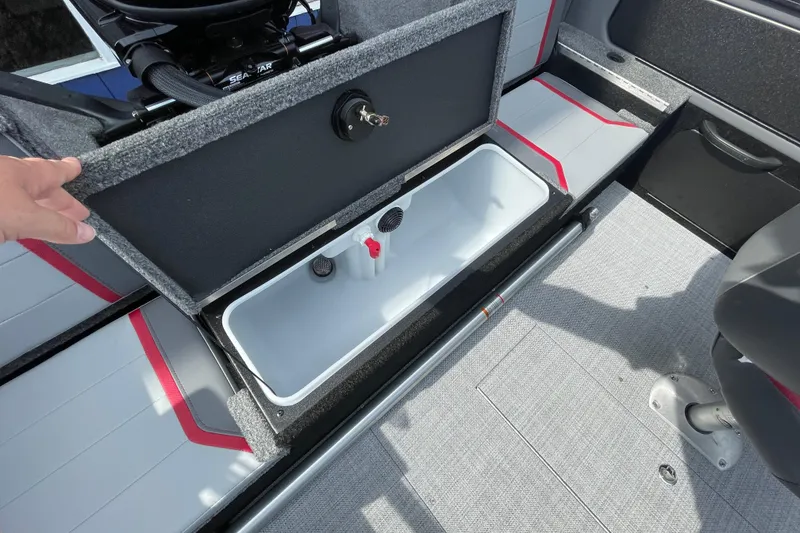 Slide: The Image of 2025 Alumacraft Trophy 185X Sport boat interior with seating and motor, in showroom setting. - 34