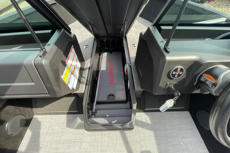 Slide: The Image of 2025 Alumacraft Trophy 185X Sport interior with seating and motor, in showroom setting. - 35