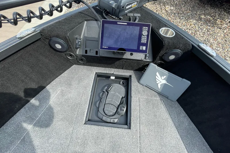 Slide: The Image of 2025 Alumacraft Trophy 185X Sport boat interior with open storage compartment. - 37