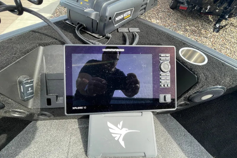 Slide: The Image of 2025 Alumacraft Trophy 185X Sport boat displayed indoors on a trailer. - 40