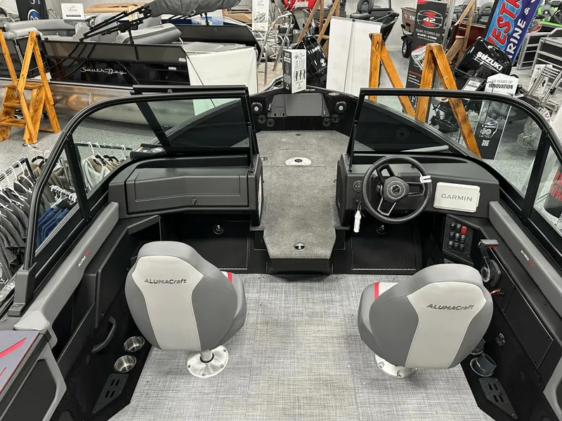 Slide: The Image of 2025 Alumacraft Trophy 185X Sport boat interior with seating and steering console. - 5