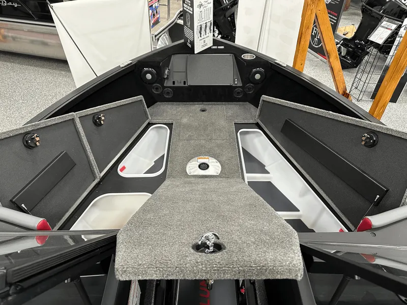 Slide: The Image of 2025 Alumacraft Trophy 185X Sport boat displayed at a marine dealership. - 7