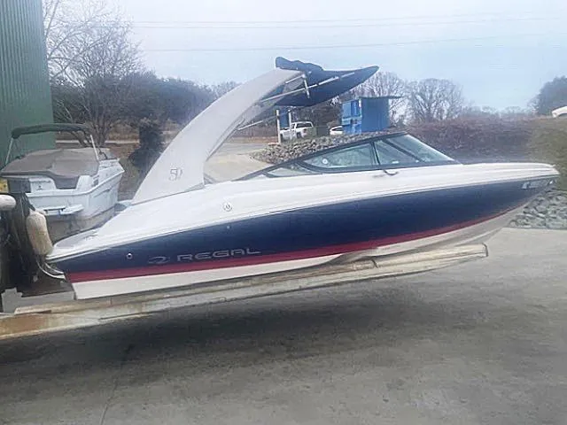 Slide: The Image of 2021 Regal 2000 ES Bowrider boat on trailer, side view, outdoors. - 2