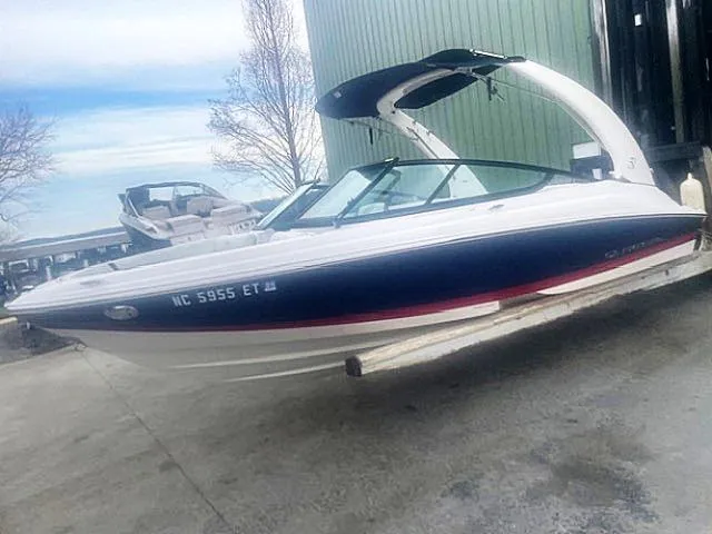 Slide: The Image of 2021 Regal 2000 ES Bowrider boat on a trailer, parked outdoors. - 3