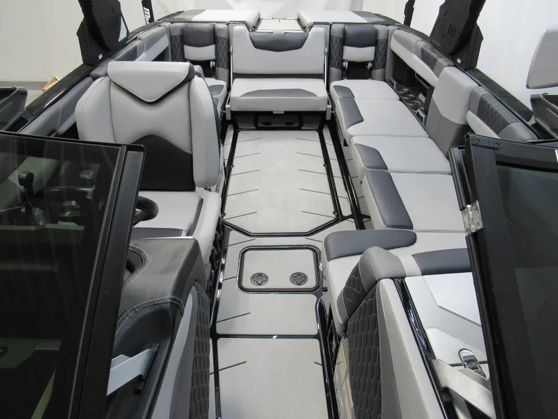 Slide: The Image of 2020 Malibu M240 boat interior with sleek, modern seating and spacious layout. - 12