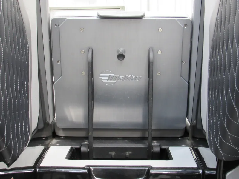 Slide: The Image of 2020 Malibu M240 boat interior with sleek seating and storage compartment. - 19