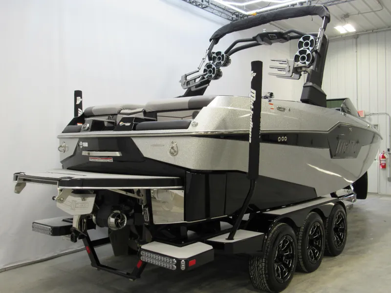 Slide: The Image of 2020 Malibu M240 boat on trailer in indoor storage facility. - 2