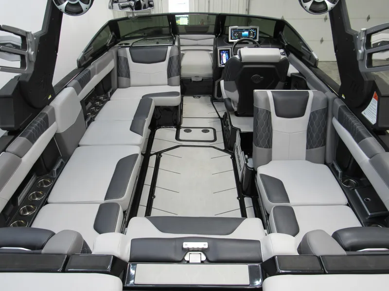 Slide: The Image of 2020 Malibu M240 boat interior with luxurious seating and modern dashboard. - 4