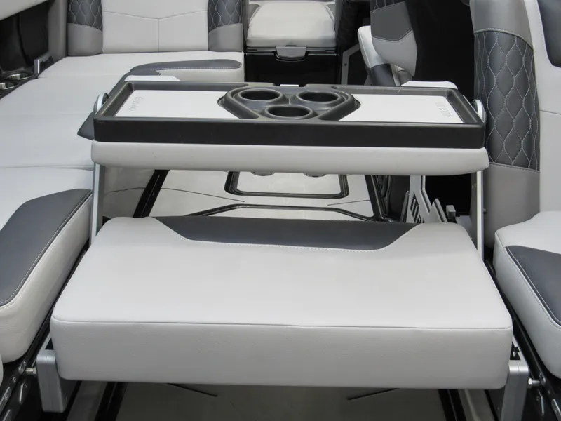 Slide: The Image of 2020 Malibu M240 boat interior with seating and cup holders. - 5