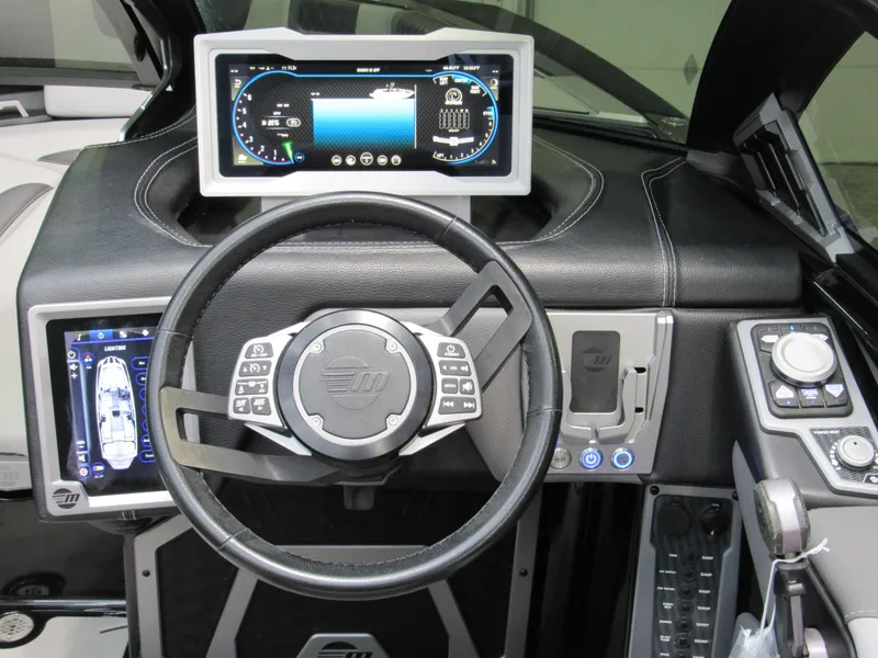 Slide: The Image of 2020 Malibu M240 boat dashboard with advanced digital controls and steering wheel. - 8