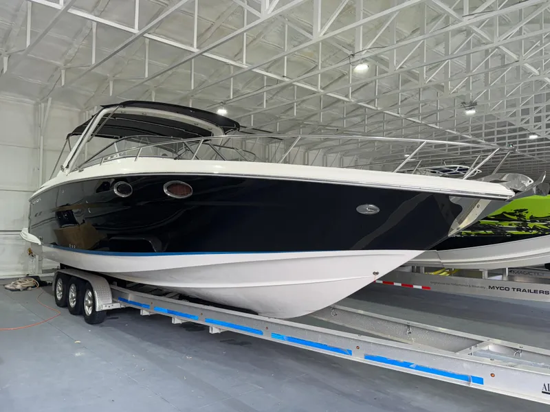 The Image of 2005 Regal 3350 Sport Cruiser on trailer in indoor storage facility. - 0