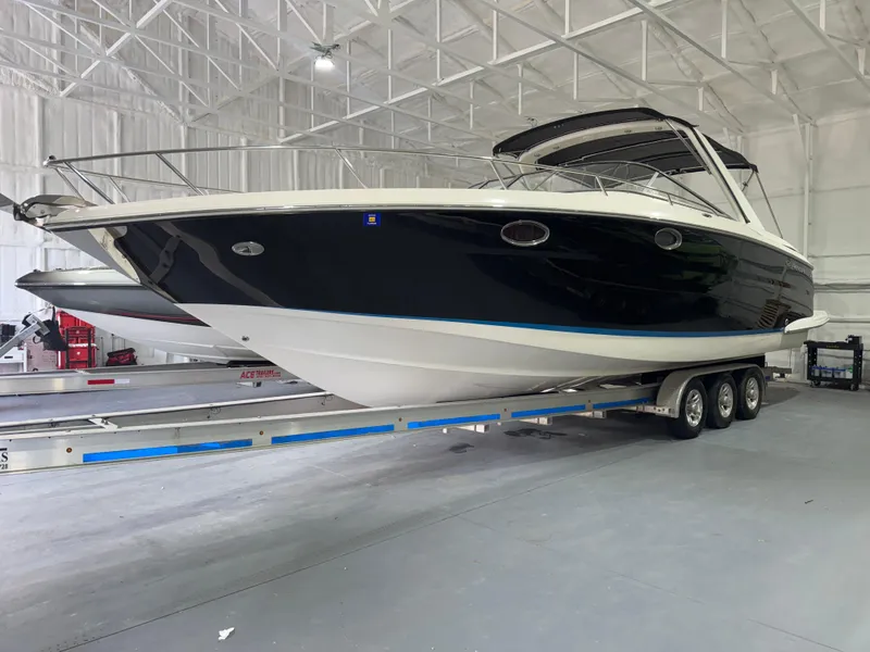 Slide: The Image of 2005 Regal 3350 Sport Cruiser on trailer in indoor storage facility. - 1