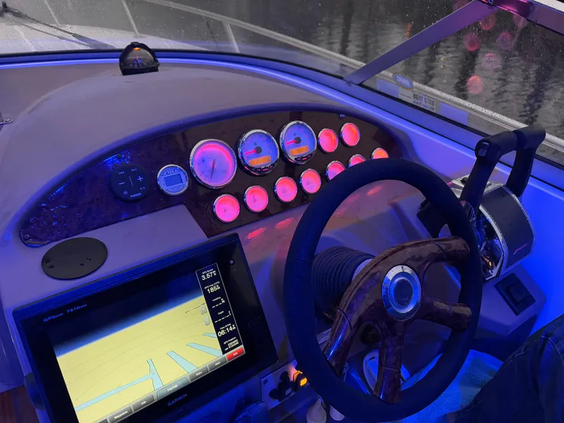 Slide: The Image of Dashboard of a 2005 Regal 3350 Sport Cruiser with illuminated gauges and navigation screen. - 10