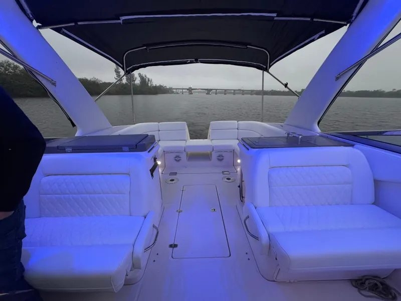 Slide: The Image of 2005 Regal 3350 Sport Cruiser interior with blue lighting on a calm waterway. - 13