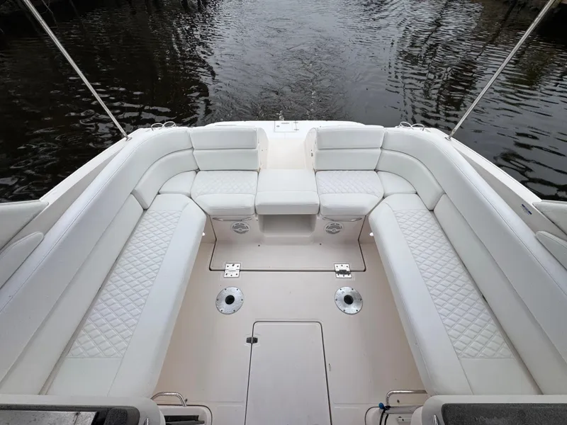 Slide: The Image of 2005 Regal 3350 Sport Cruiser interior with white seating, overlooking water. - 15