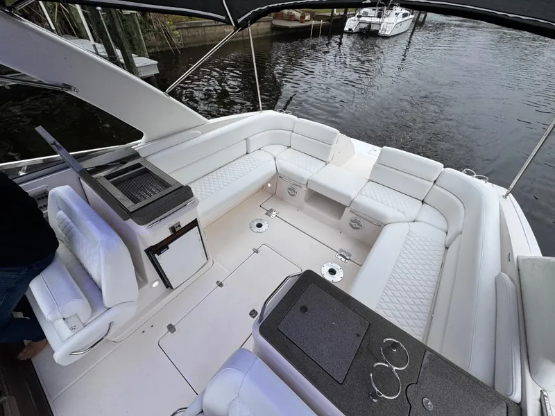 Slide: The Image of 2005 Regal 3350 Sport Cruiser with spacious seating and sleek design on the water. - 17