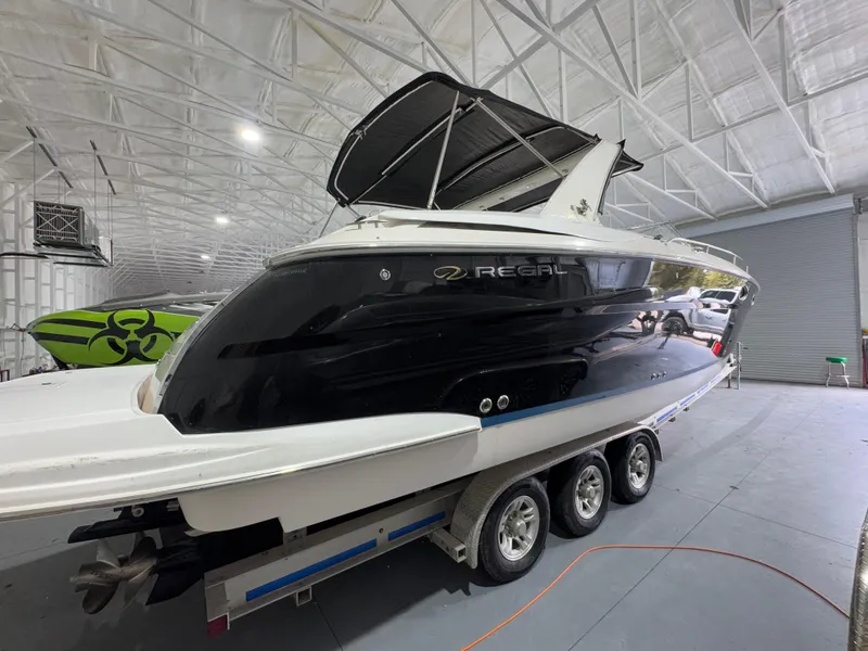 Slide: The Image of 2005 Regal 3350 Sport Cruiser in a spacious indoor storage facility. - 2