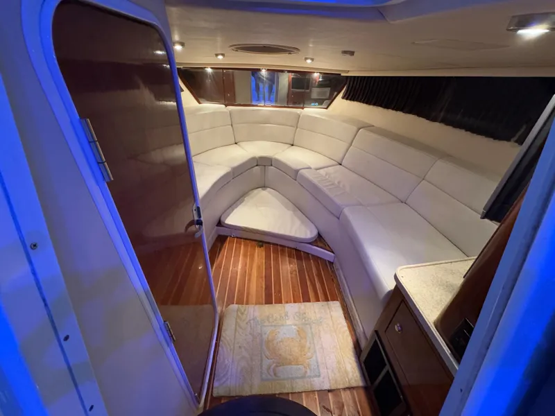 Slide: The Image of 2005 Regal 3350 Sport Cruiser interior with plush seating and wood flooring. - 20