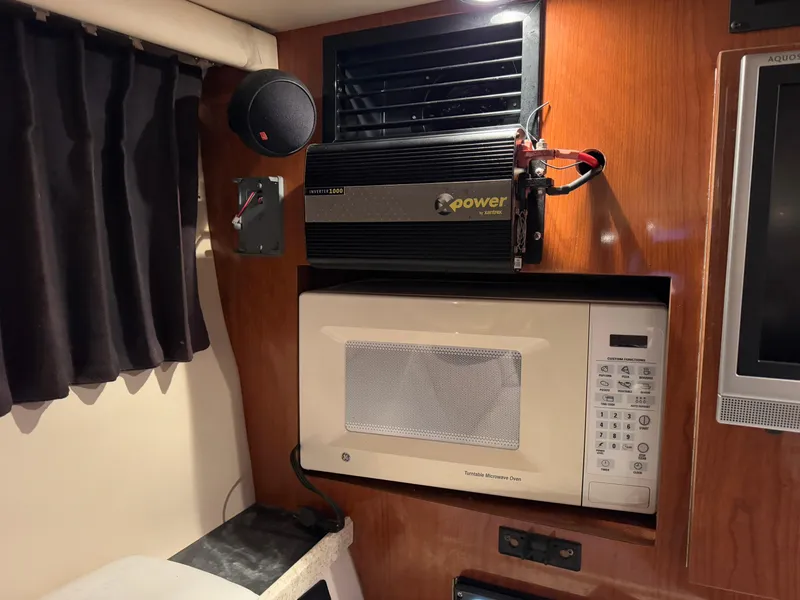 Slide: The Image of 2005 Regal 3350 Sport Cruiser interior with microwave and power inverter. - 23