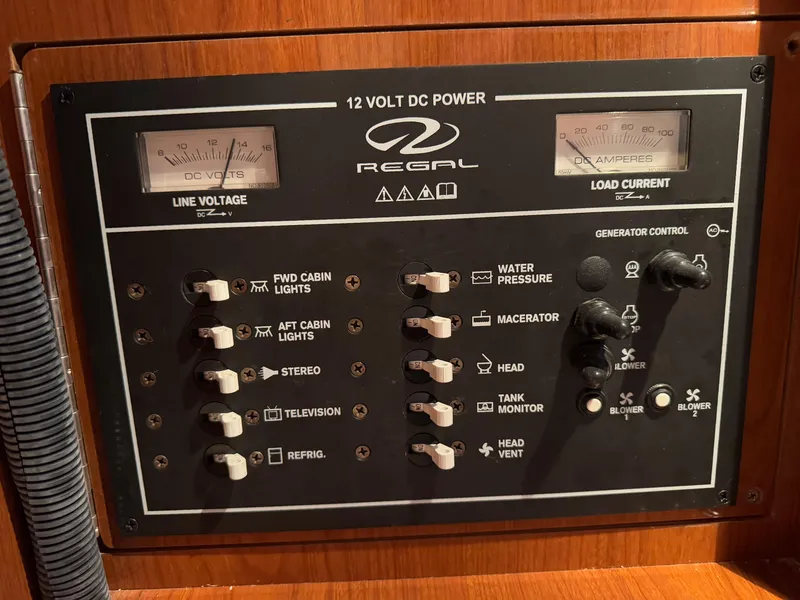 Slide: The Image of Control panel of a 2005 Regal 3350 Sport Cruiser, showing 12V DC power switches. - 26
