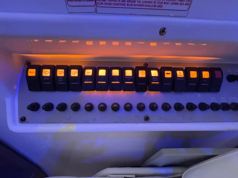 Slide: The Image of Control panel of a 2005 Regal 3350 Sport Cruiser with illuminated switches. - 27
