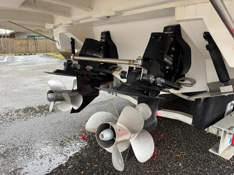 Slide: The Image of 2005 Regal 3350 Sport Cruiser propellers and outdrives on wet pavement. - 33