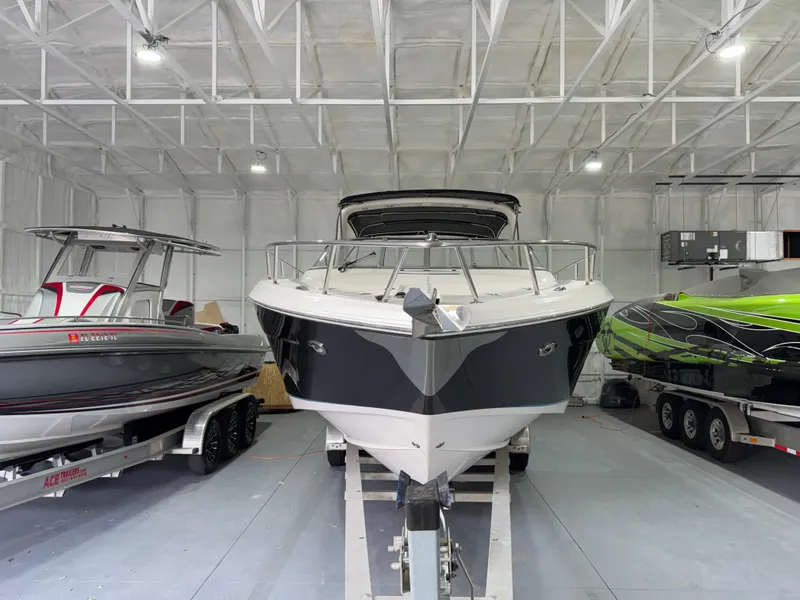Slide: The Image of 2005 Regal 3350 Sport Cruiser in storage, flanked by two other boats. - 4