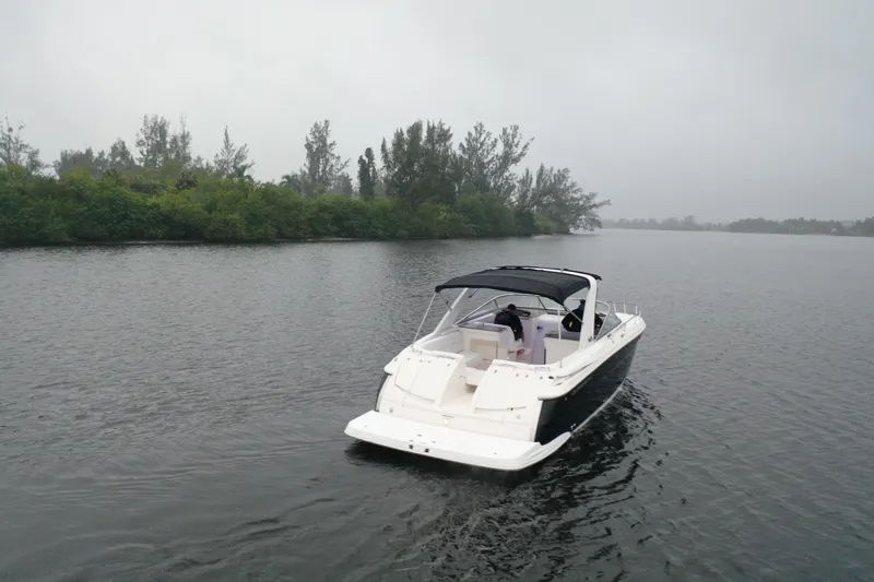 Slide: The Image of 2005 Regal 3350 Sport Cruiser on a calm lake with overcast skies. - 7
