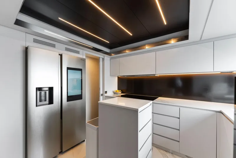 Slide: The Image of Modern kitchen interior on 2023 Riva Dolcevita yacht, featuring sleek white cabinetry and appliances. - 45