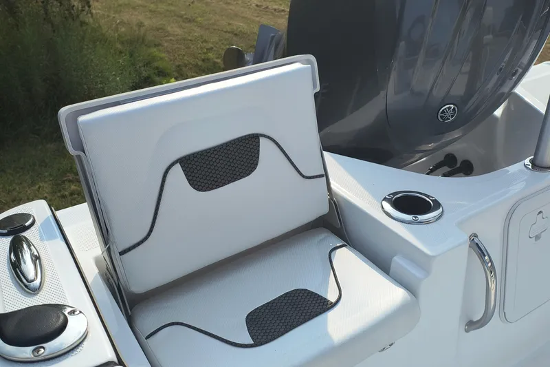 Slide: The Image of 2025 Wellcraft 202 Fisherman boat seat and console detail with cup holder. - 11