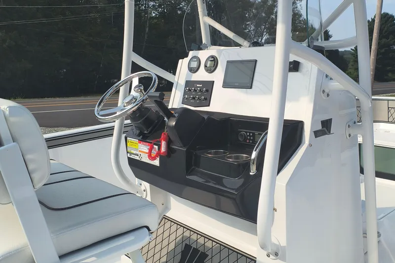 Slide: The Image of 2025 Wellcraft 202 Fisherman boat console with steering wheel and navigation controls. - 12
