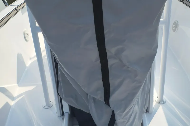 Slide: The Image of 2025 Wellcraft 202 Fisherman boat interior with protective cover. - 16