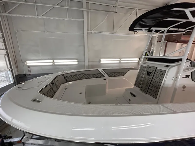Slide: The Image of 2025 Wellcraft 202 Fisherman boat in a showroom, featuring sleek design and spacious interior. - 5