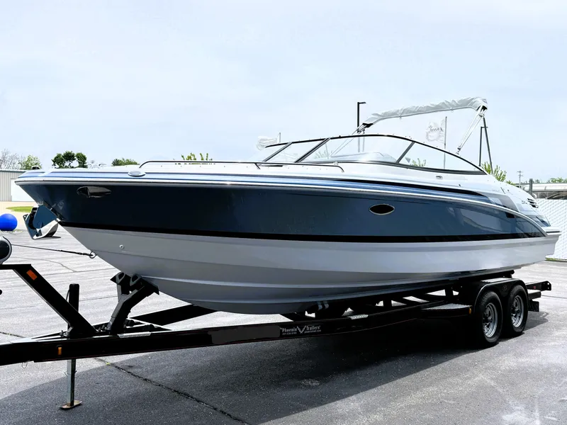 Slide: The Image of 2025 Formula 270 Bowrider boat on trailer, sleek design, parked outdoors. - 2